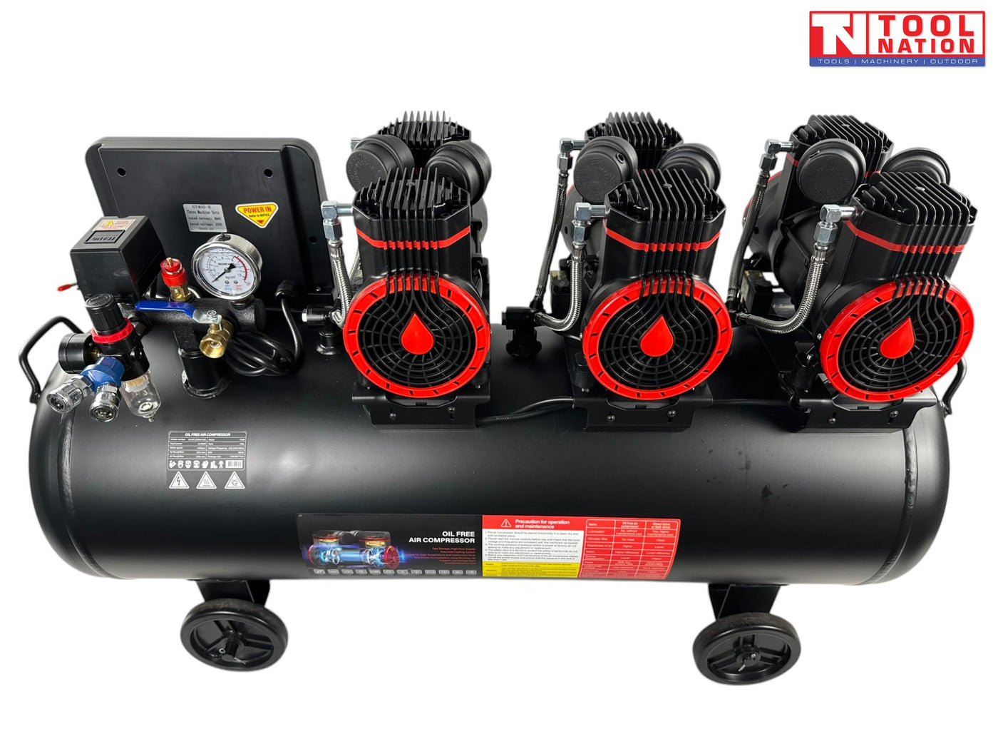 Front angled view of the oil-free air compressor showing six pump units, three motors, control panel, handle and 100 litre tank.