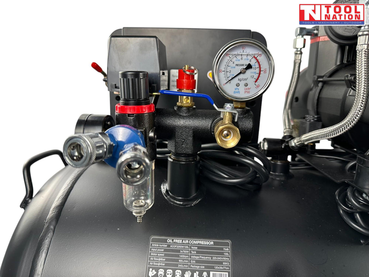 Close-up of the dual pressure gauges, regulator, outlet fitting and filter bowl on the oil-free air compressor.
