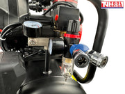 Close-up of the regulator, dual pressure gauges, outlet fitting and filter bowl on the oil-free air compressor.