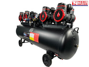 Front three-quarter view of the oil-free air compressor showing eight pump units, regulator assembly, controller box, black tank and wheels.