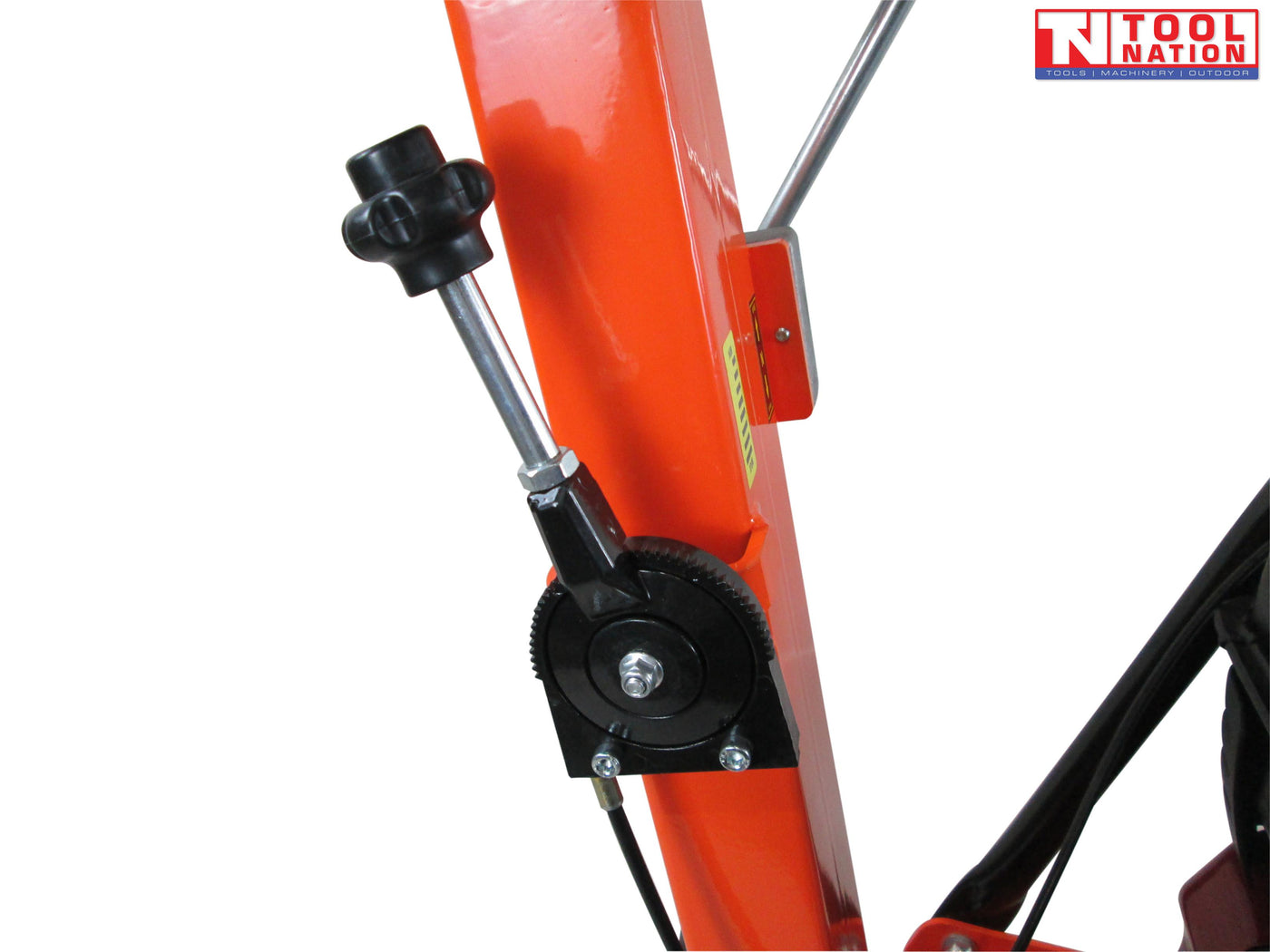 Close-up of an orange plate compactor handle adjustment area with a black knob, metal rod, bolts, and warning label.