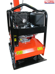 Rear view of an orange plate compactor with petrol engine, protective frame, black base plate, handle, and warning labels.