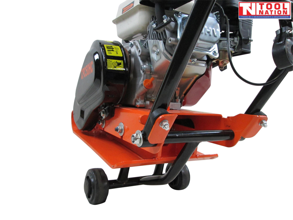Close-up rear view of an orange plate compactor showing the petrol engine, black belt cover, handle frame, wheels, and logo in the top corner.