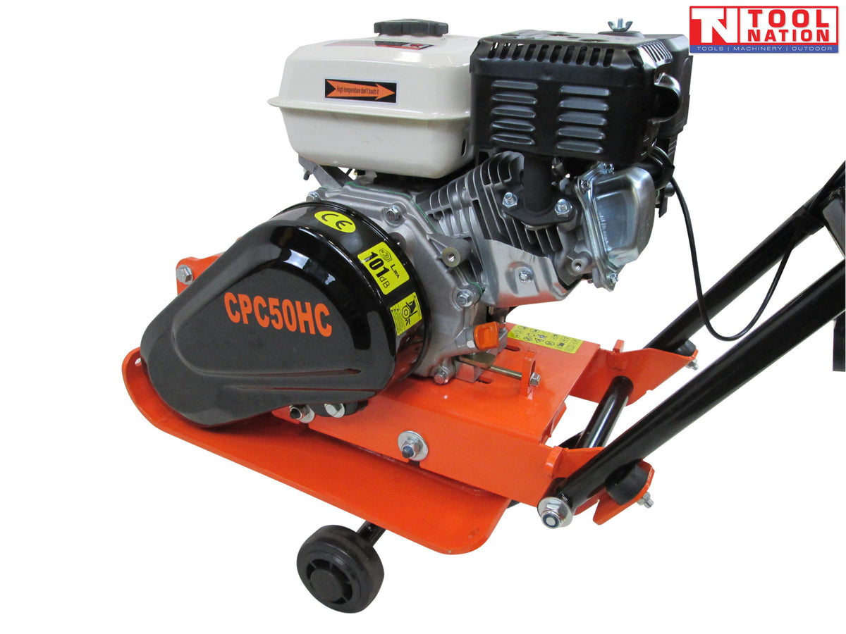 Close-up side view of an orange plate compactor showing the petrol engine, black belt cover, base plate, wheel, and logo in the top corner.