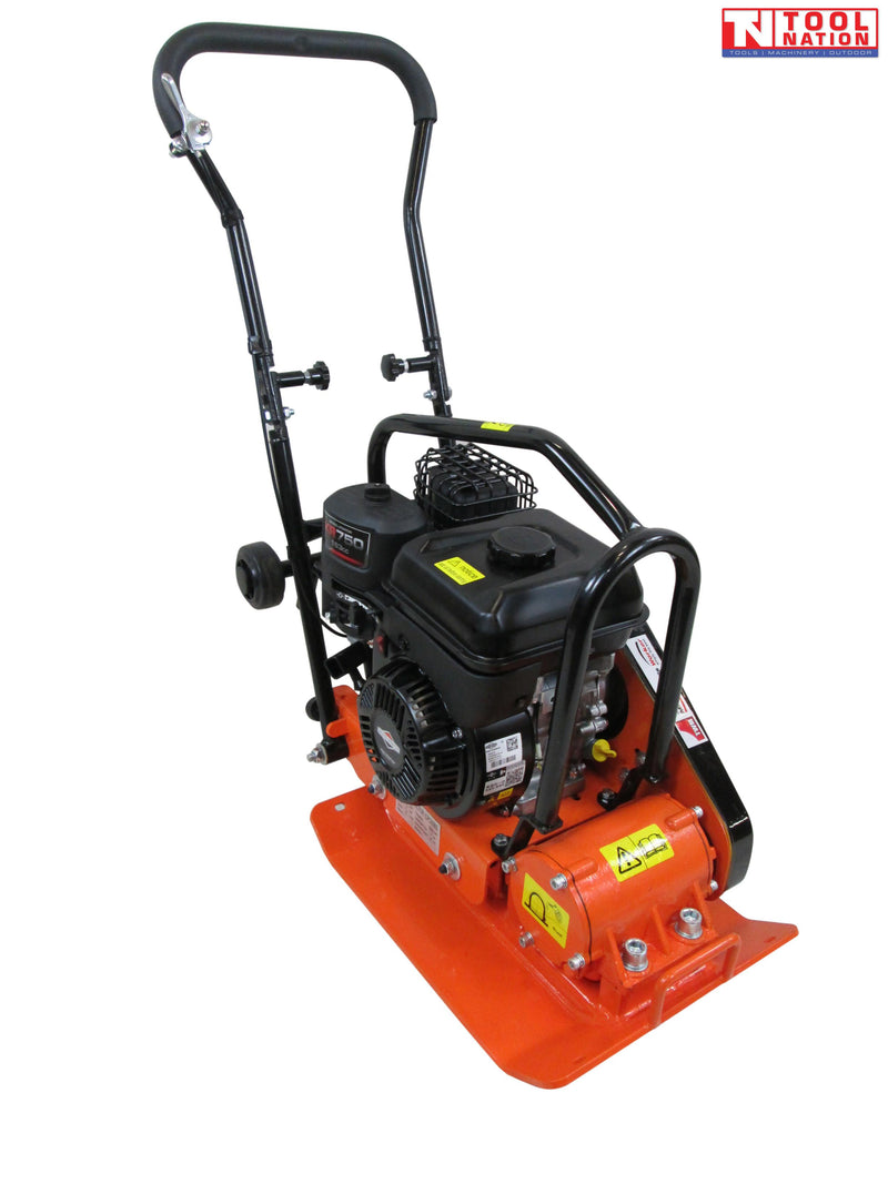 Orange plate compactor with petrol engine, black handle, wheels, protective frame, warning labels, and logo in the top corner.