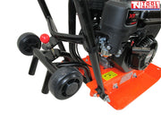 Close-up rear view of an orange plate compactor showing the wheel kit, handle frame, petrol engine, base plate, bolts, and labels.