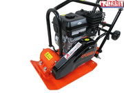 Close-up angled view of an orange plate compactor showing the petrol engine, protective frame, black belt cover, base plate, wheels, and labels.