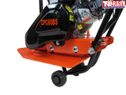 Close-up side view of an orange plate compactor showing the black belt cover, base plate, wheel, handle frame, and visible model text.
