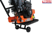 Close-up rear view of an orange plate compactor showing the petrol engine, base plate, wheel kit, handle frame, bolts, labels, and logo in the top corner.