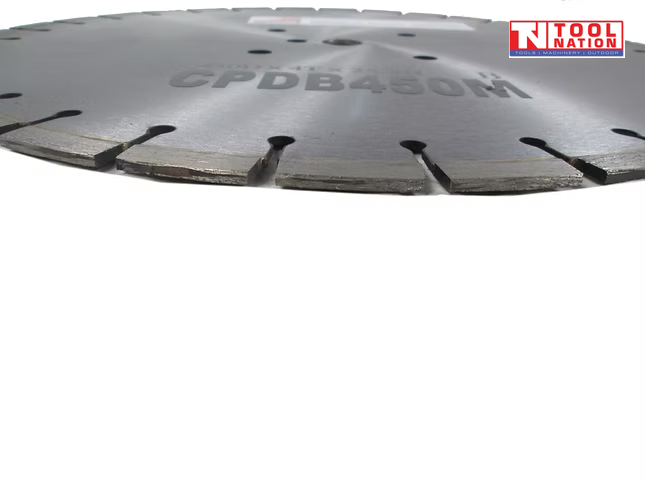 Low close-up of a silver segmented diamond cutting blade showing the segmented cutting edge, centre holes, faint printed text, and logo in the top corner.