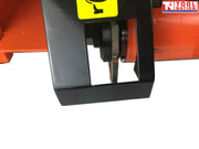 Close-up of a concrete grooving machine cutting blade inside a black guard with orange frame visible behind it.