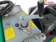 Close-up of a floor saw height adjustment area showing the hand wheel, vertical lever, labels, bolts, and engine section.