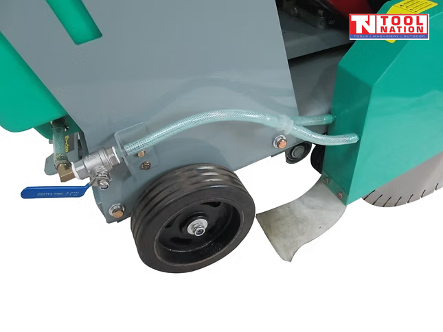 Close-up of a floor saw lower side showing the wheel, clear hose, teal blade guard, and grey frame.