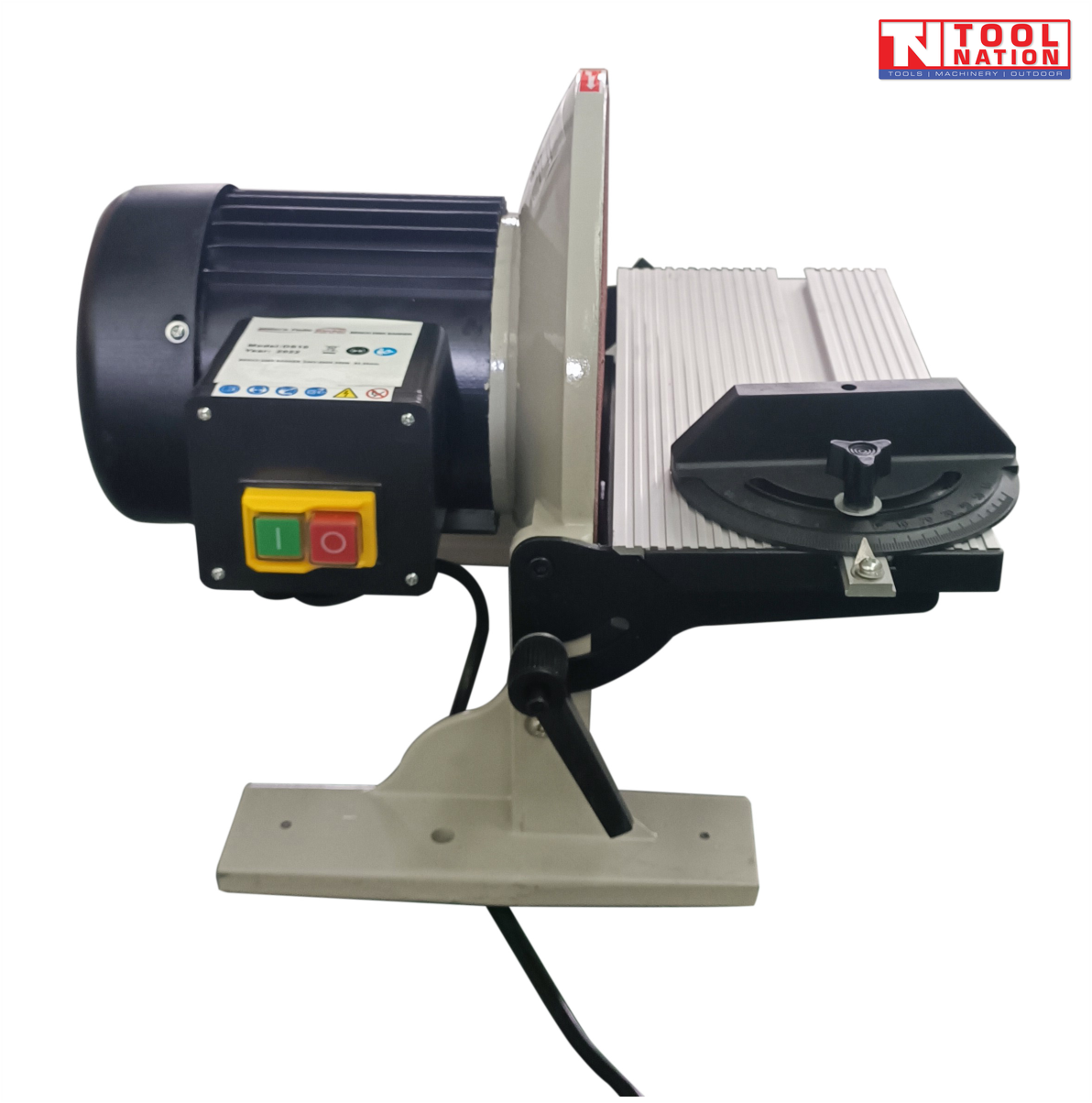 Side view of a bench disc sander with black motor housing, front power switch, silver work table, angle guide, tilt handle, and logo in the top corner.