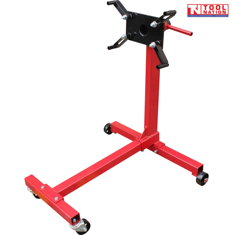 Engine stand angled view with red frame, black rotating mounting head, handle, and four casters
