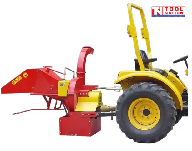 Red and yellow wood chipper attached behind a yellow tractor, with a feed hopper, curved discharge chute, rear wheel, and logo in the top right corner.