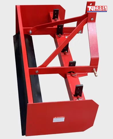 Red box grader attachment with black ripper tines, triangular mounting frame, pins, bolts, and a logo in the top right corner.