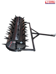 Black towable spiked roller shown from the end with a rectangular frame, drawbar, metal pin and Tool Nation logo.