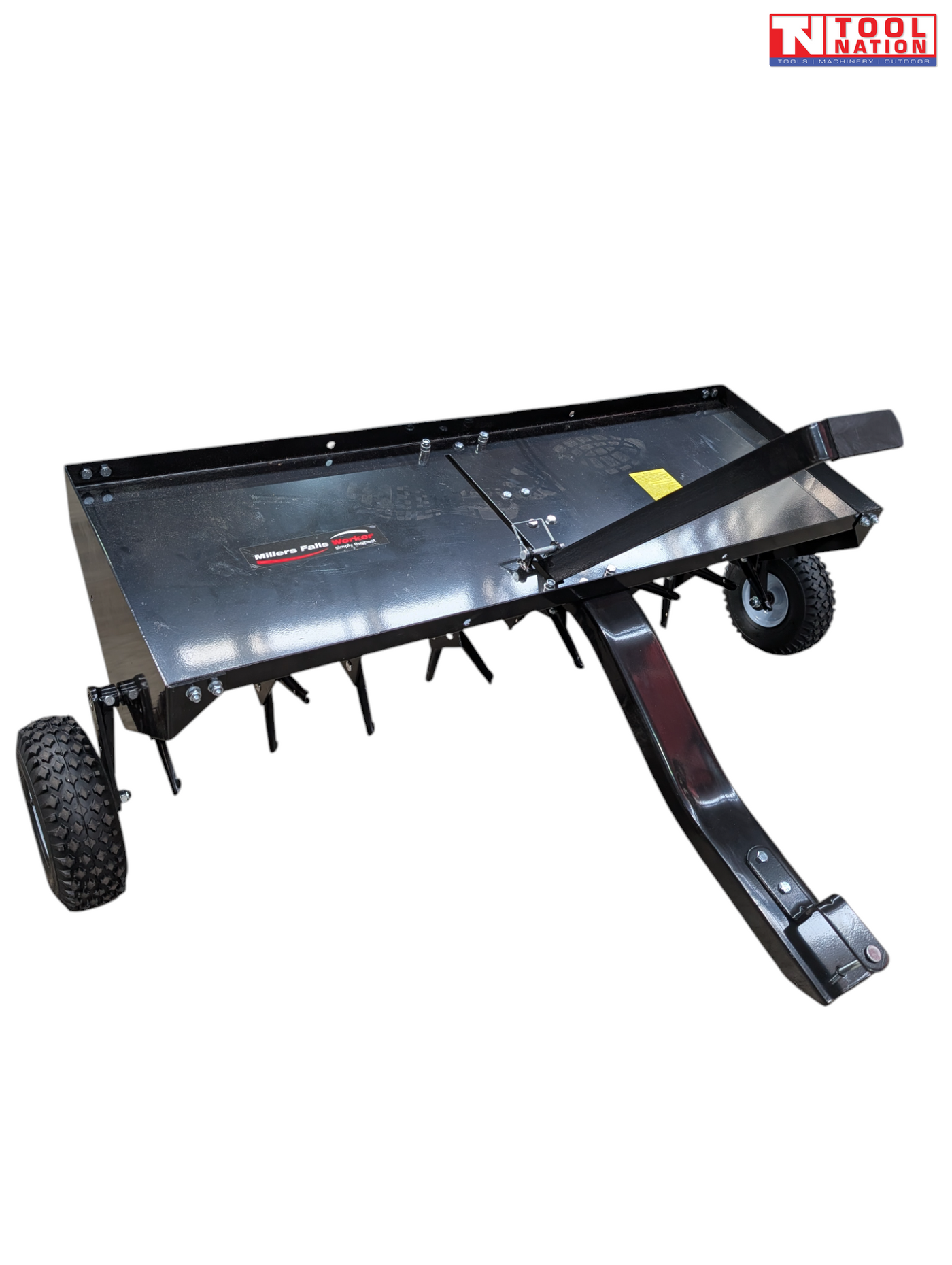 Black towable lawn aerator shown from above with a tray, drawbar, upright handle, two tyres and visible coring tines underneath.