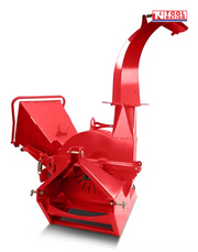 Close-up of a black internal chipper disc with visible bolts and blades beside red machine panels.