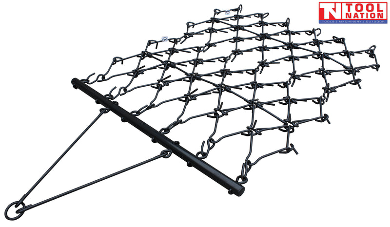 Black drag harrow with a grid of hooked tines, front tow bar, tow ring, and a logo in the top right corner.