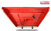 Underside view of a red slasher attachment with cutting bar, bolts, chains, and a logo in the top right corner.