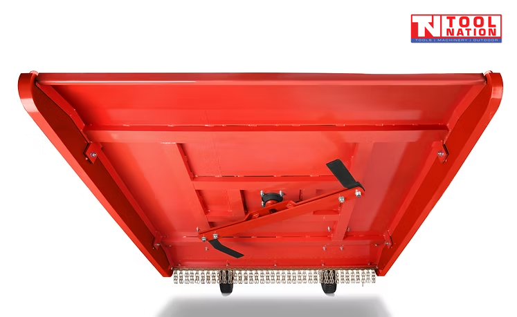 Underside view of a red slasher attachment with cutting bar, bolts, chains, wheels, and a logo in the top right corner.