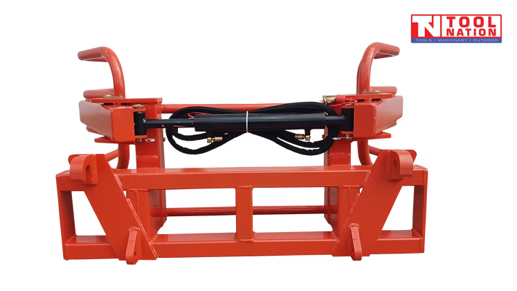 Front view of a red bale gripper frame with black hydraulic cylinder, curved arm ends, hook brackets, and logo in the top right corner.