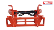 Front view of a red bale gripper frame with black hydraulic cylinder, curved arm ends, hook brackets, and logo in the top right corner.
