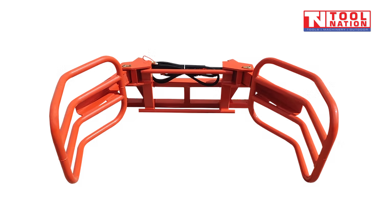 Top view of a red bale gripper with two curved gripping arms, rectangular frame, black hydraulic cylinder, and logo in the top right corner.