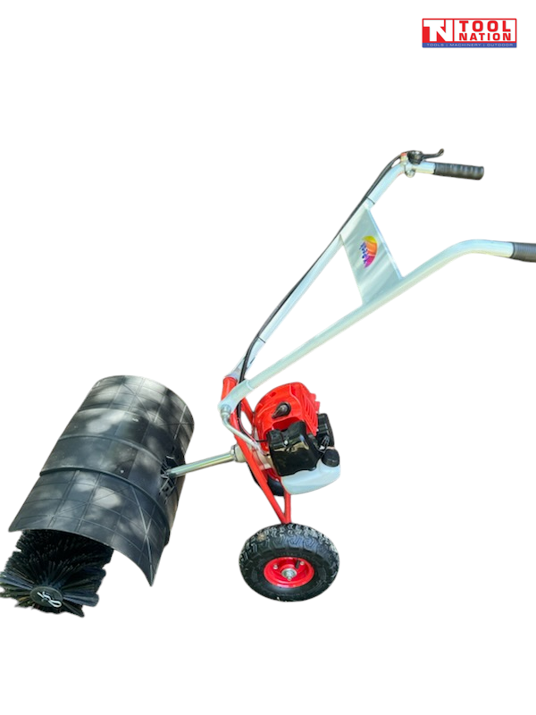 Red and white walk-behind power broom shown from the side with black brush bristles, black curved guard, one visible tyre, handles and Tool Nation logo.