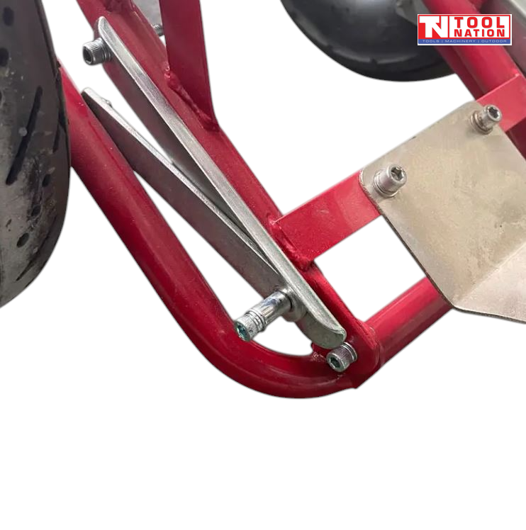 Close-up of a red frame section with metal brackets, bolts and parts of two black tyres visible.