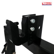 Close-up of the top hook area on a black quick hitch attachment, showing silver bolts, adjustment holes, and a logo in the top right corner.
