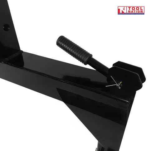 Close-up of a black spring handle and side hook on a quick hitch attachment, with a logo in the top right corner.