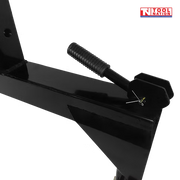 Close-up of a black spring handle and side hook on a quick hitch attachment, with a logo in the top right corner.