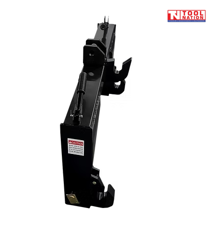 Side view of a black quick hitch attachment with spring handle, top hook brackets, side hooks, pins, warning label, and a logo in the top right corner.