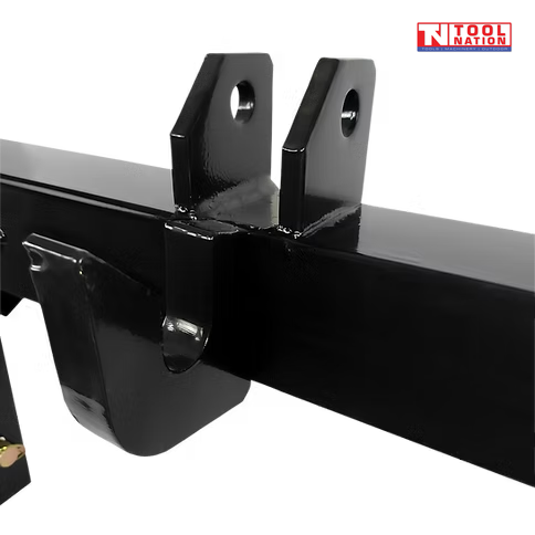 Close-up of the top hook bracket area on a black quick hitch attachment, with bolt holes and a logo in the top right corner.
