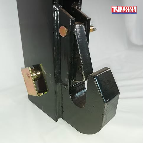 Close-up of a black side hook, latch plate, pins, and bolts on a quick hitch attachment.