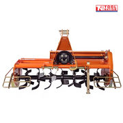Front view of an orange rotary tiller with black curved tines, triangular mounting frame, pulley cover, guard rails, chains, and a logo in the top right corner.