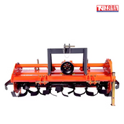 Front view of an orange rotary tiller with black curved tines, black mounting frame, guard rail, support leg, and a logo in the top right corner.