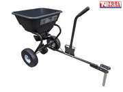 Black tow-behind spreader with an open hopper, long drawbar, upright handle, two treaded tyres, metal pin and Tool Nation logo.