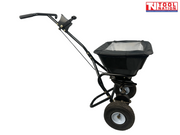Black walk-behind spreader shown from the side with a covered hopper, long handle, two treaded tyres and Tool Nation logo.