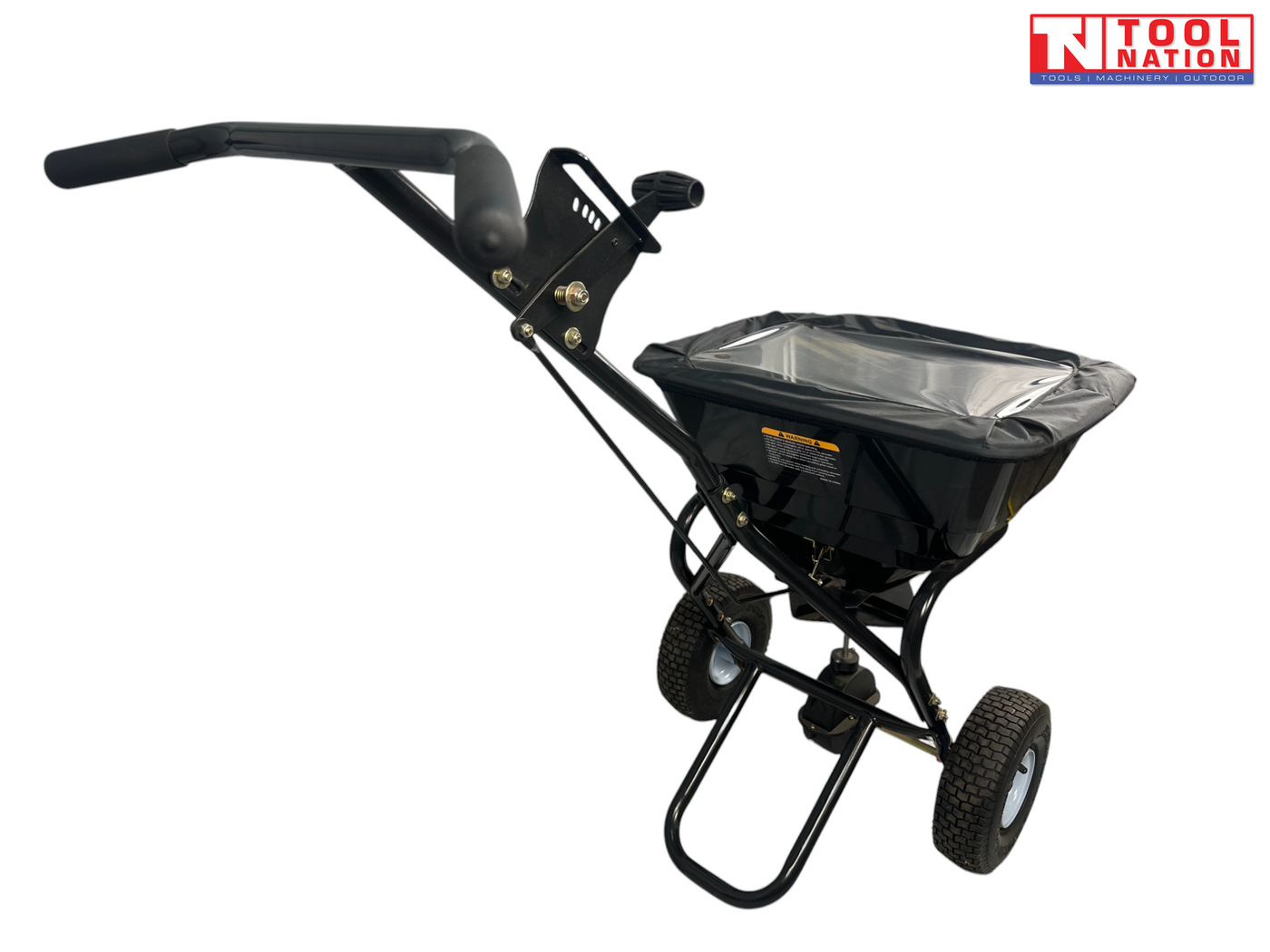 Black walk-behind spreader shown from above with a covered hopper, long handle, two treaded tyres and Tool Nation logo.