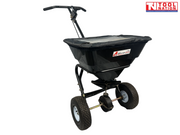 Black walk-behind spreader shown from the front side with a covered hopper, long handle, two treaded tyres and Tool Nation logo.