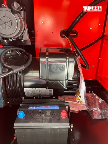 Internal view of the generator showing the battery, motor, wiring, and enclosed components.