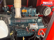 Internal view of the generator engine and surrounding components inside the red enclosure.