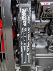 Close-up of an engine component identification plate mounted inside the generator.