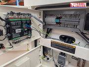 Internal electrical compartment with control modules, wiring, breakers, and terminal connections inside the generator.
