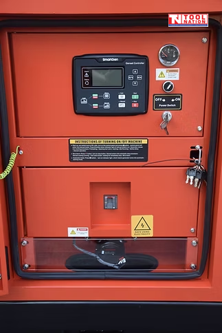 Close-up of the generator control panel with Smartgen controller, gauge, power switch, key switch, and warning labels.