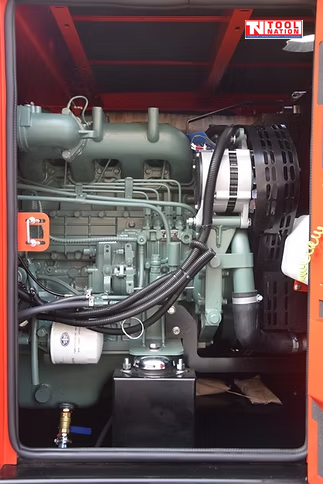 Close-up of the engine compartment showing the diesel engine, hoses, alternator, and internal components.
